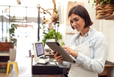 Small business owner using tablet in hospitality environment