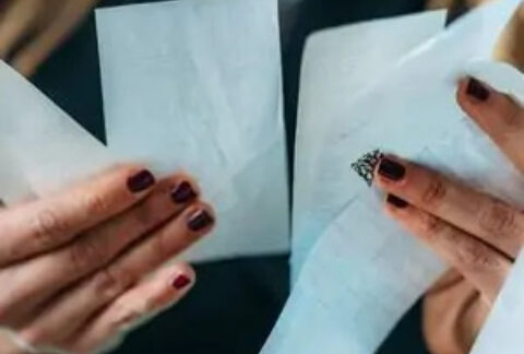 Businesswoman's hands holding receipts