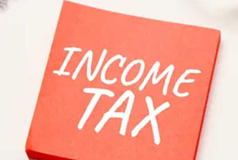 Post-it note with 'income tax' written on it