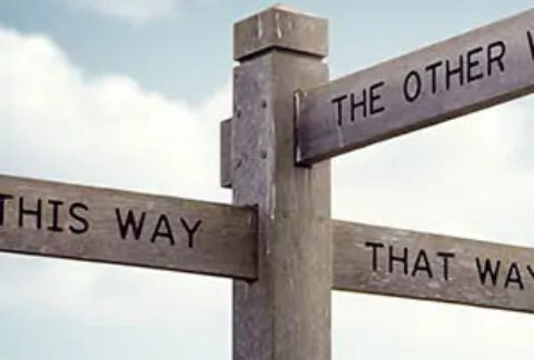 Wooden signpost with signs reading 'this way', 'that way' and 'the other way'