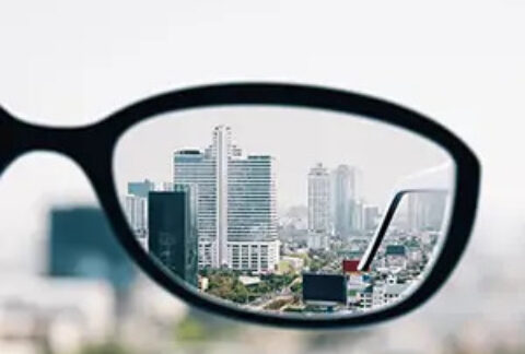 Cityscape views through one lens of a pair of glasses