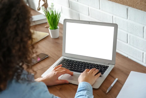 Businesswoman at desk working on laptop