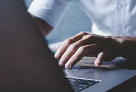 Businessman at desk working on laptop