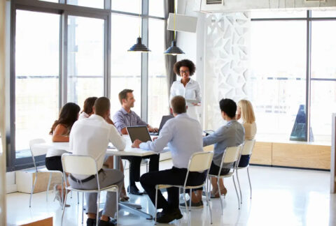 SME sat around table in business meeting