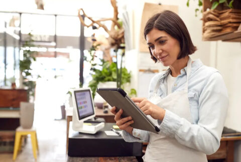 Small business owner using tablet in hospitality environment