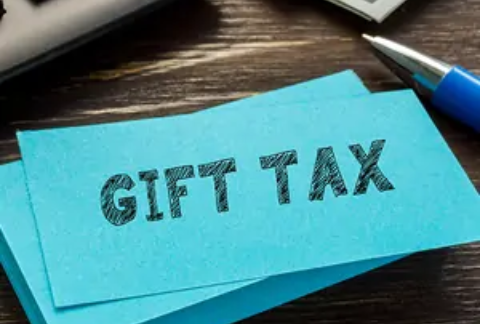 Post-it note on desk with 'gift tax' written on it