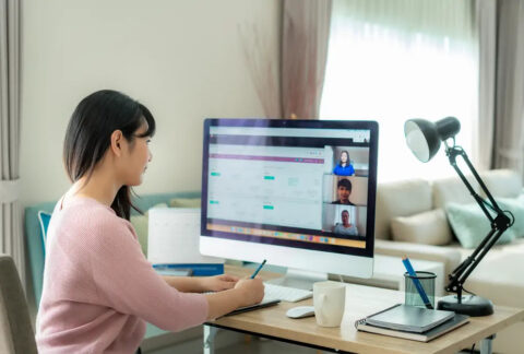Businesswoman on conference call on computer at home