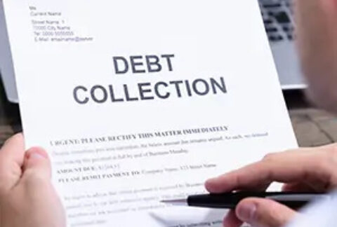 Businessman reading and pointing at debt collection letter with pen