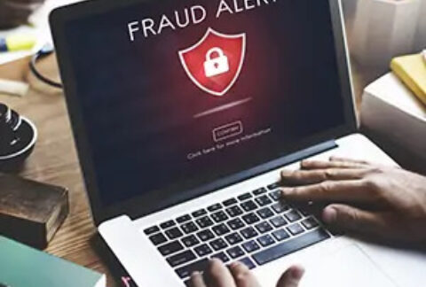 Laptop screen displaying 'fraud alert' warning