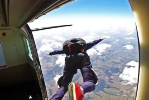 Man jumping out of plane to skydive