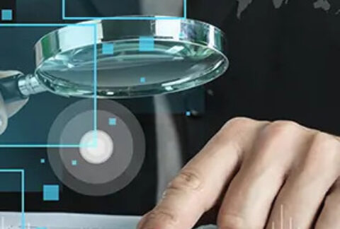 Businessman looking through magnifying glass at finger pointing at document overlayed with technology graphics