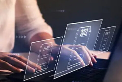 Businesswoman at desk overlayed with images of document files