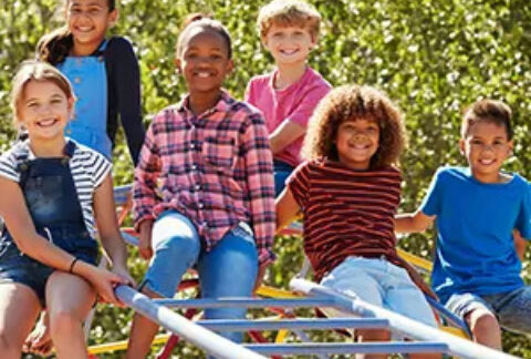 Group of children posing for photo in park
