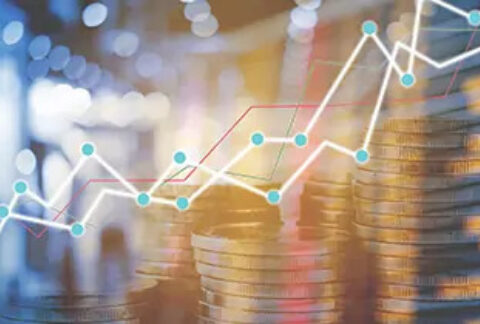 Increasing graph lines in front of stacks of coins