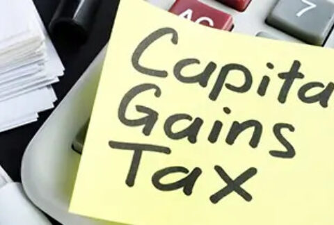 Post-it note on top of a calculator with 'Capital Gains Tax' written on it