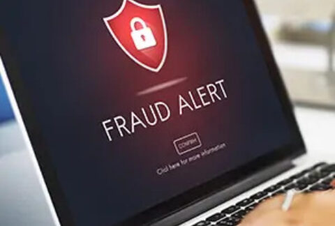 Laptop screen displaying 'fraud alert' warning