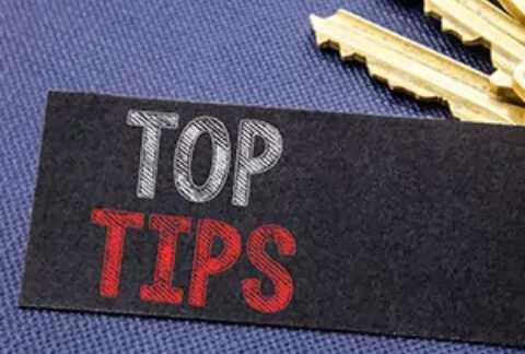 Piece of fabric with 'top tips' written on it in front of a set of three gold keys