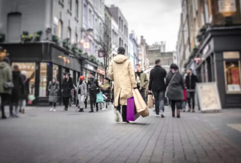 Blurred shoppers on street
