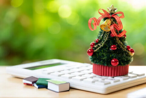 Miniature Christmas tree on top of calculator