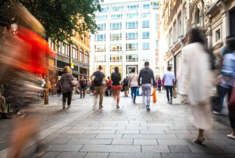 Blurred crowds walking on street