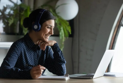Businesswoman working on laptop with headset