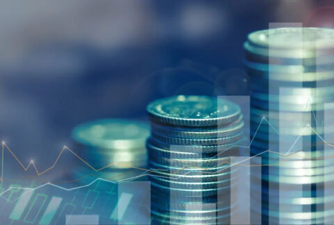 Three stacks of coins overlayed with images of graphs