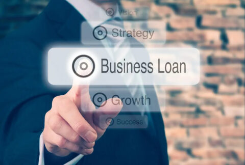 Businessman tapping image of 'business loan' button among other buttons of 'vision', 'strategy', 'growth' and 'success'