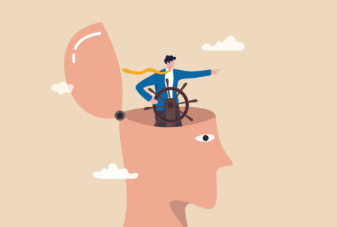 Cartoon of a giant head with the skull wide open on a hinge, with a businessman inside the head steering a ship steering wheel and pointing ahead
