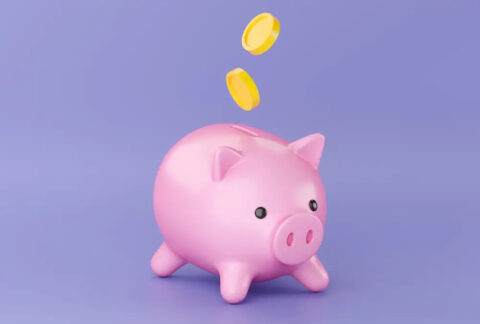 Cartoon piggy bank with two coins falling into slot
