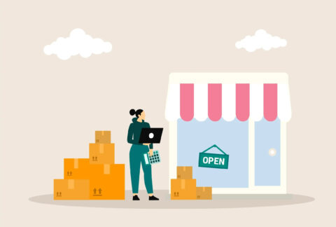 Cartoon of woman standing next to shopfront holding open laptop and calculator with a pile of cardboard boxes on either side of her
