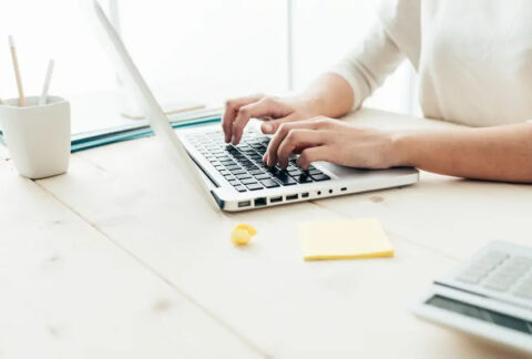 Businesswoman working on laptop at desk