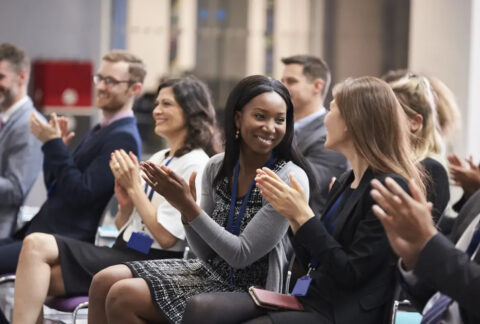 Businesspeople applauding at hospitality conference